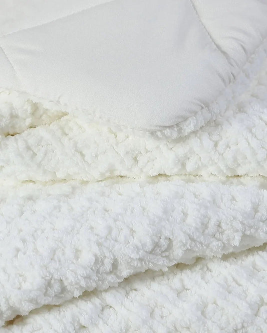 Close-up of off-white Snug Waffle comforter showing plush waffle texture detail with smooth bamboo viscose reverse side and white pillow