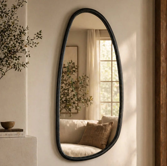 Blackwash mango wood wall mirror styled in a warm living room reflecting natural light with organic black frame and neutral decor