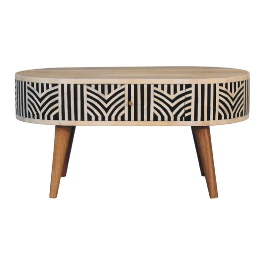Oval bone inlay coffee table with black, bone, and oak chevron pattern, center drawer, tapered wood legs on a white background