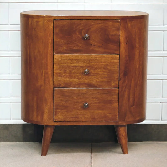 Chestnut solid wood compact cabinet styled against white tile wall showing three drawers silver knobs and Nordic splayed legs