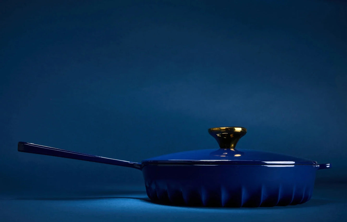 Side profile of the Oxford Blue FIREUP skillet highlighting the thin fin design base and hanging hole handle.