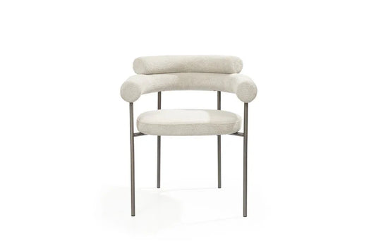 Light gray boucle dining arm chairs featuring a unique open back design and durable gunmetal stainless steel frames.