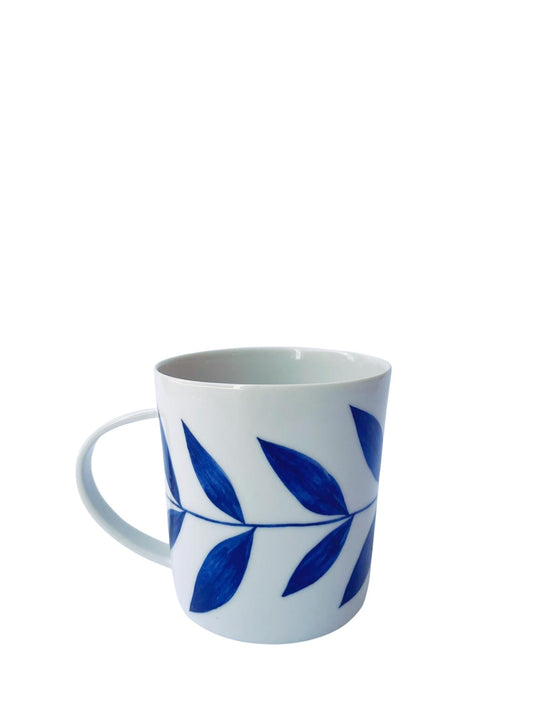 Lhasa porcelain mug with blue botanical leaf glaze tapered silhouette handcrafted Limoges