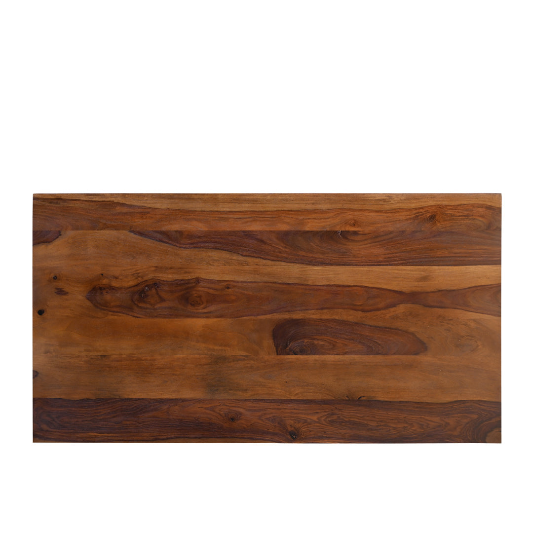 Flat lay of solid seesham wood coffee table top showing sweeping natural grain pattern with contrasting dark and warm amber tones across the wide rectangular surface