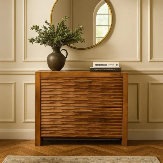 Heirloom quality handcrafted solid wood sideboard with carved wave front panels styled in a warm entryway with a round mirror and ceramic vase