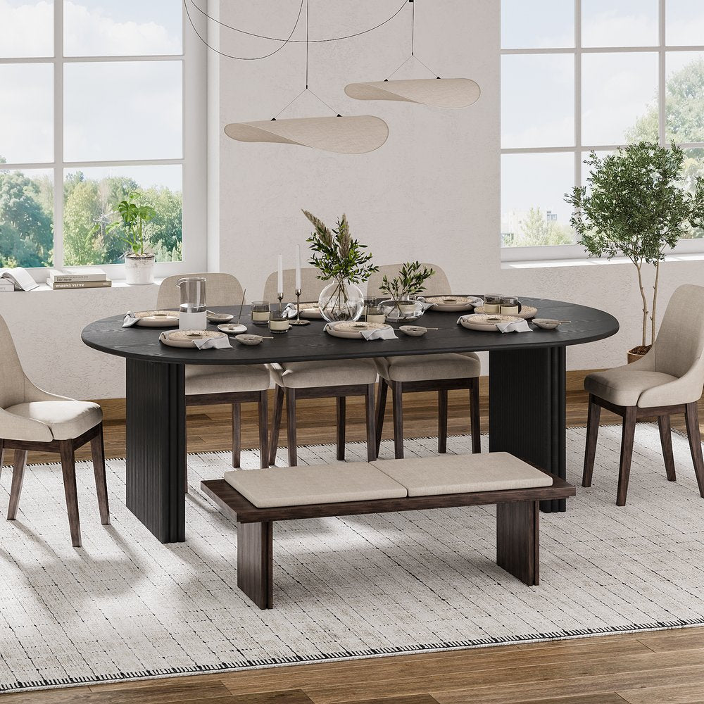 Elegant solid wood dining table in a dark finish styled with contemporary upholstered chairs and a matching bench.