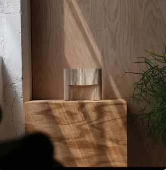 Corduroy stoneware table lamp in a warm, sunlit architectural setting — Fluent Trends