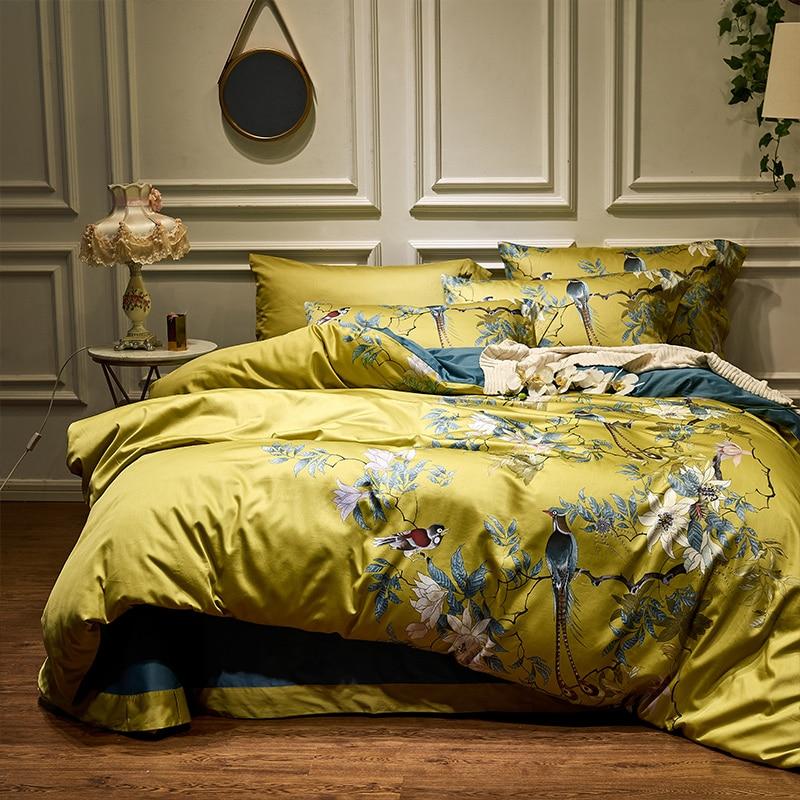Luxury comforter sets and premium duvet covers in a rich chartreuse green floral print styled on a bed with teal accents and elegant wall molding