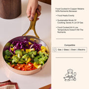 Copper frypan with brass handle, filled with colorful chopped vegetables like broccoli, bell peppers, and cabbage.