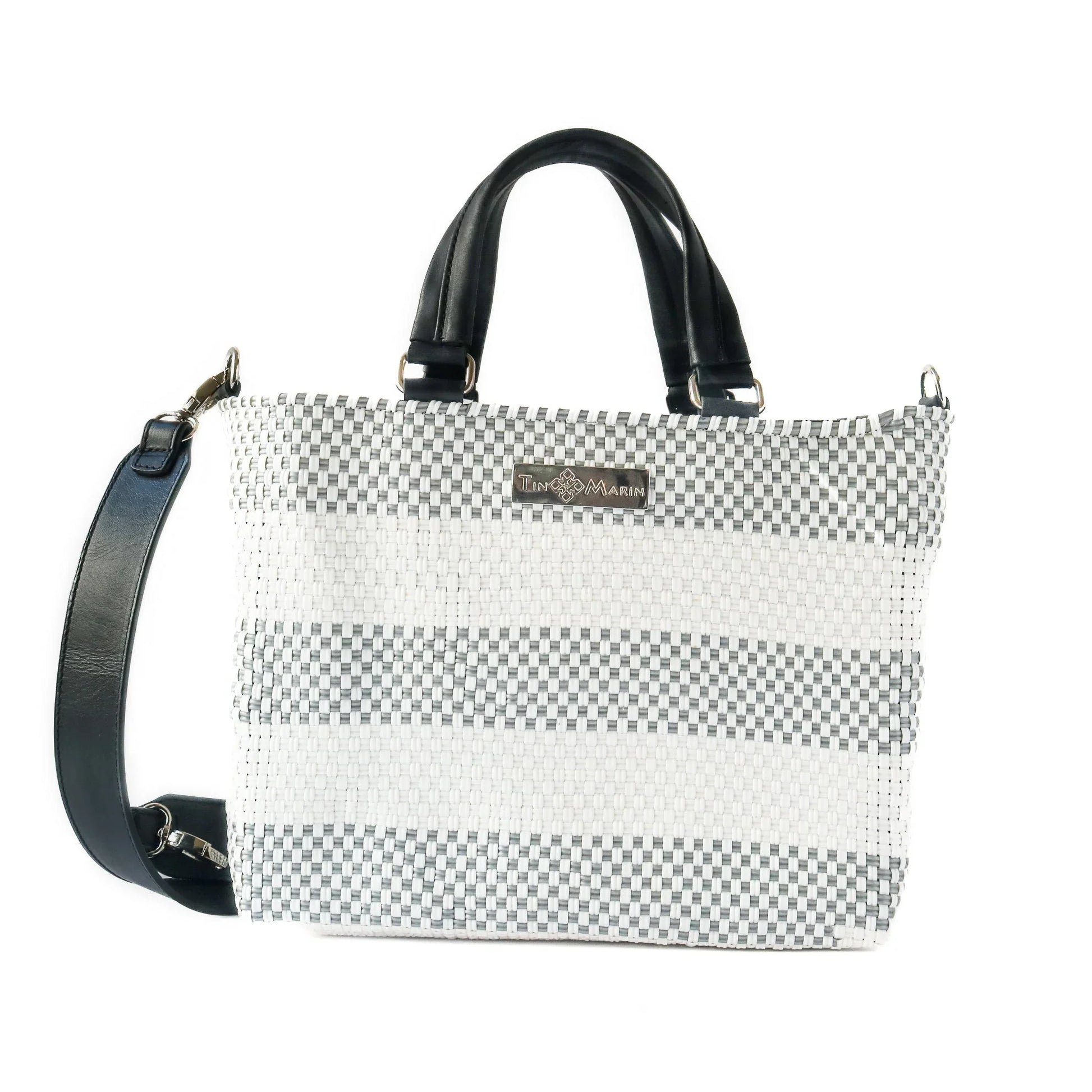 Gray and white woven tote bag with black leather handles and adjustable shoulder strap