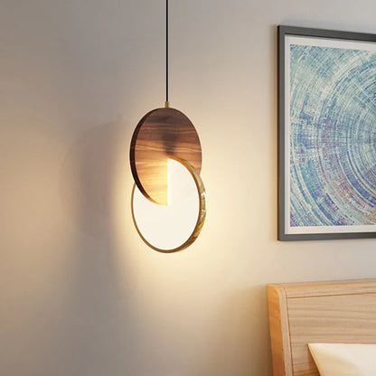 Modern wooden pendant light with illuminated disc and warm walnut finish