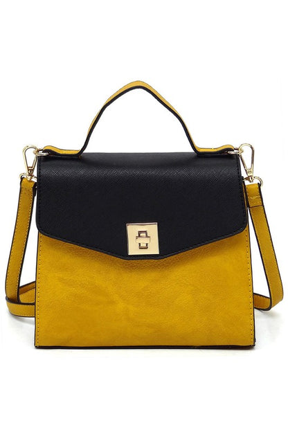 Yellow and black leather handbag with top handle and gold clasp closure on white background