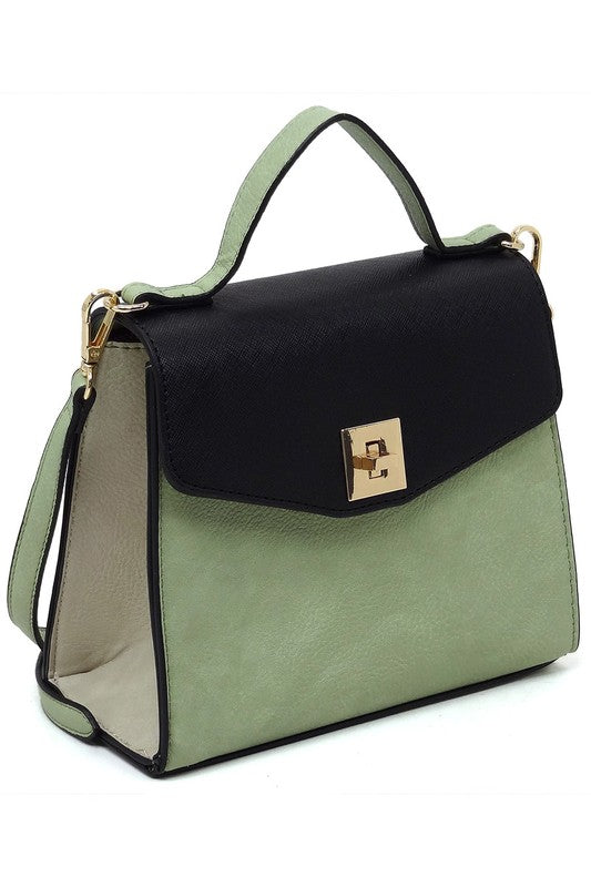 Two-tone green and black leather handbag with gold clasp and top handle on white background