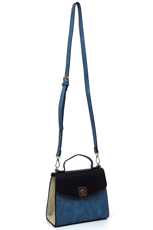 Blue and black leather handbag with gold clasp and adjustable strap on white background