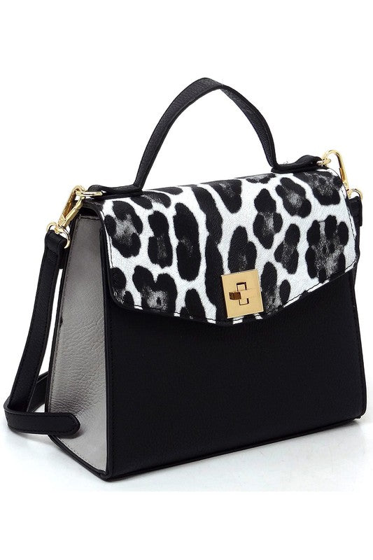 Black handbag with white and black leopard print flap and gold clasp, featuring top handle and detachable shoulder strap