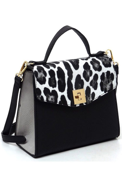 Black handbag with white and black leopard print flap and gold clasp, featuring top handle and detachable shoulder strap
