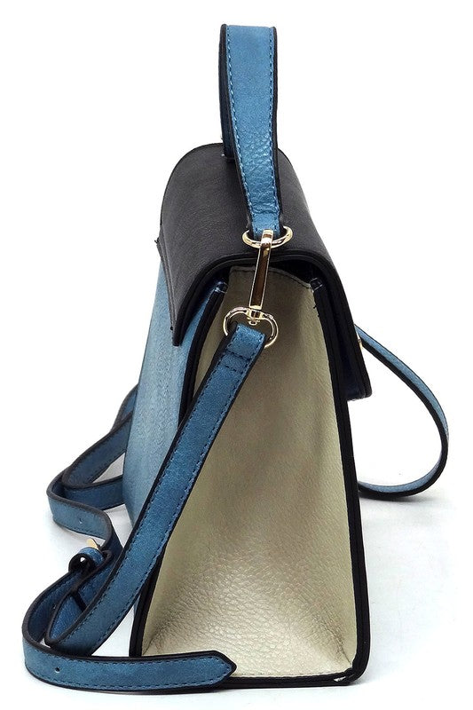 Side view of a blue and black leather shoulder bag with gold hardware and adjustable strap