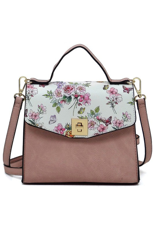 Pink leather handbag with floral and butterfly print flap and gold clasp, detachable shoulder strap