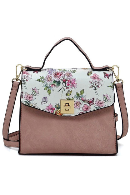 Pink leather handbag with floral and butterfly print flap and gold clasp, detachable shoulder strap
