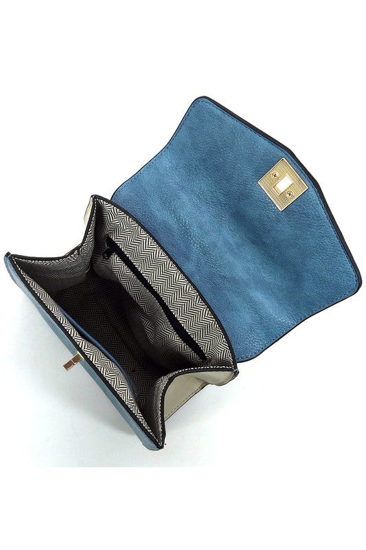 Open blue leather clutch purse showing black and white herringbone fabric lining and gold clasp