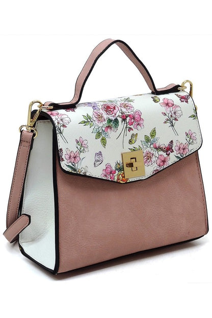 Stylish handbag with pink base, floral butterfly print flap, gold clasp, and top handle