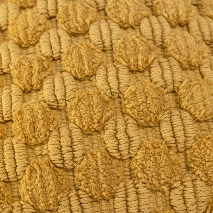 Close-up of textured yellow wool fabric with raised circular patterns, home decor textile