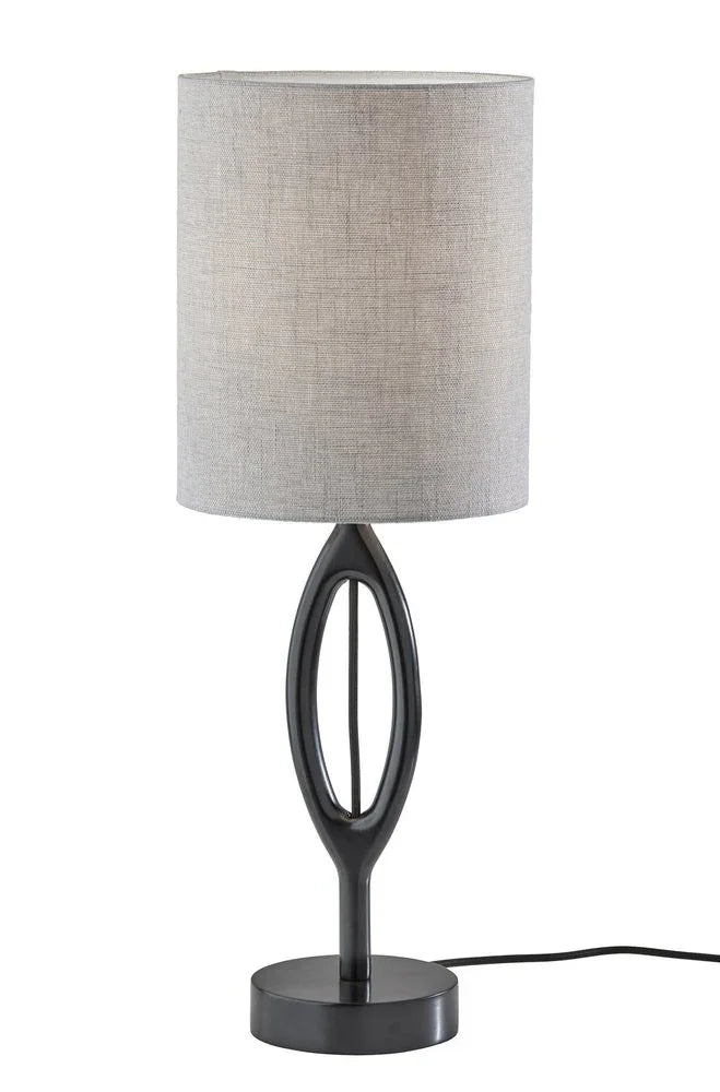 Black wood table lamp featuring a gray drum fabric shade and a sculpted oval silhouette on a clean white background.