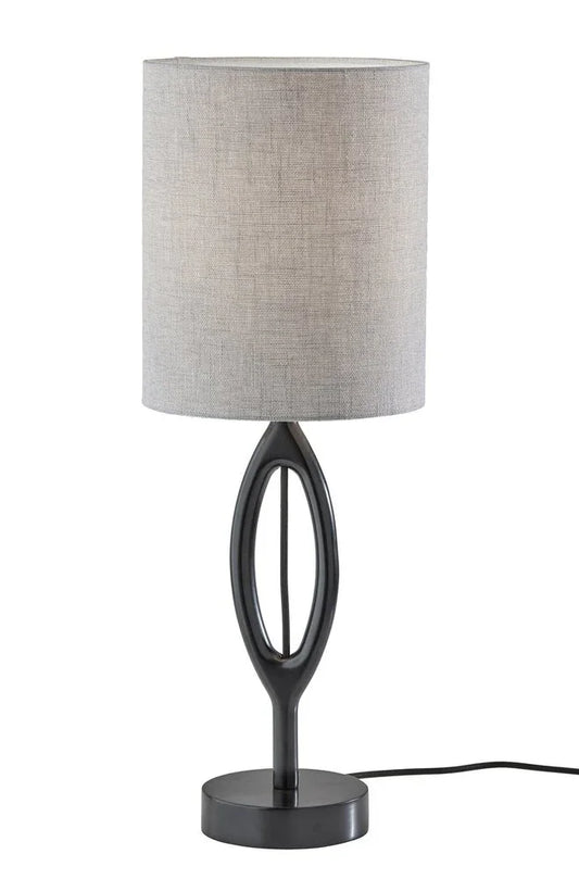 Black wood table lamp featuring a gray drum fabric shade and a sculpted oval silhouette on a clean white background.