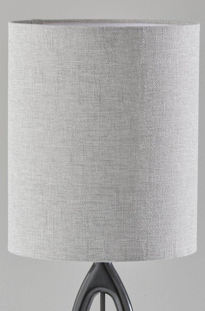 Close-up of the gray drum fabric shade of the black wood table lamp featuring a textured linen-like weave and threaded uno shade fitter.