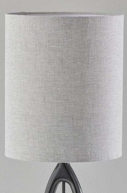 Close-up of the gray drum fabric shade of the black wood table lamp featuring a textured linen-like weave and threaded uno shade fitter.