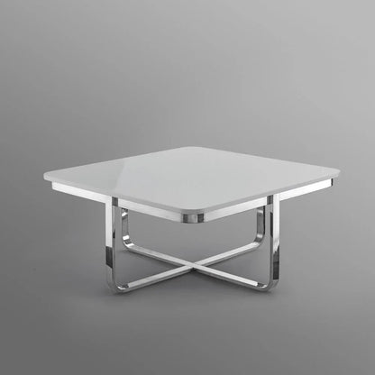 Modern square white coffee table with chrome metal crossed legs on grey background