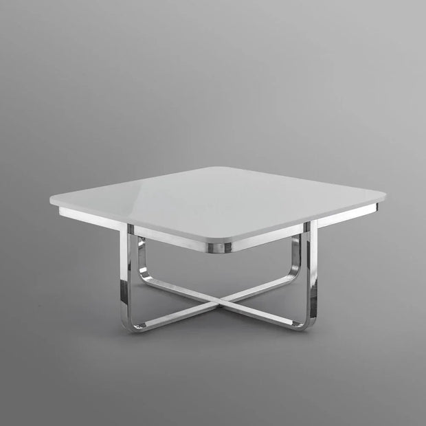 Modern square white coffee table with chrome metal crossed legs on grey background