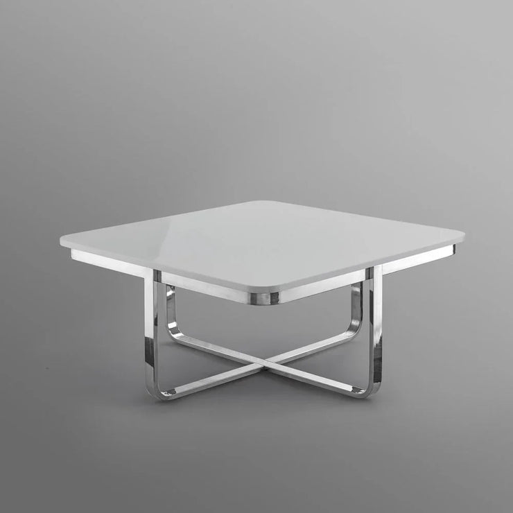 Modern square white coffee table with chrome metal crossed legs on grey background
