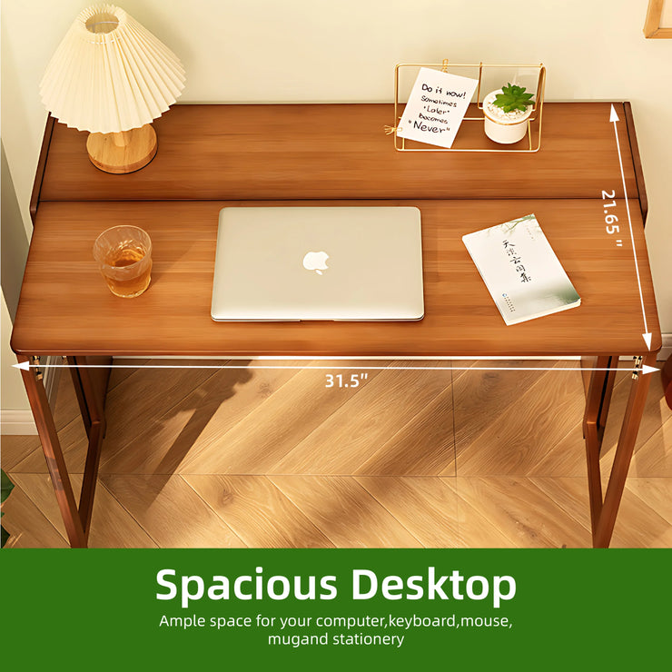 Bamboo folding desk in brown with a laptop, lamp, and decor. Features a spacious desktop, 31.5" wide by 21.65" deep.