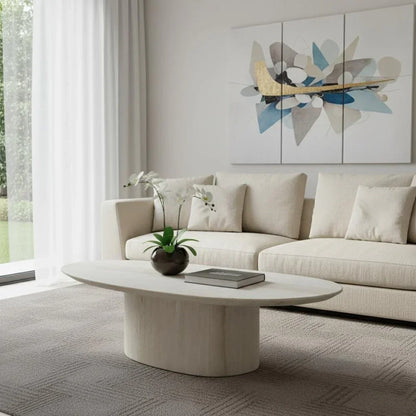 Sia 51-inch beige genuine marble oval pedestal coffee table with a matte finish in a contemporary living room setting.
