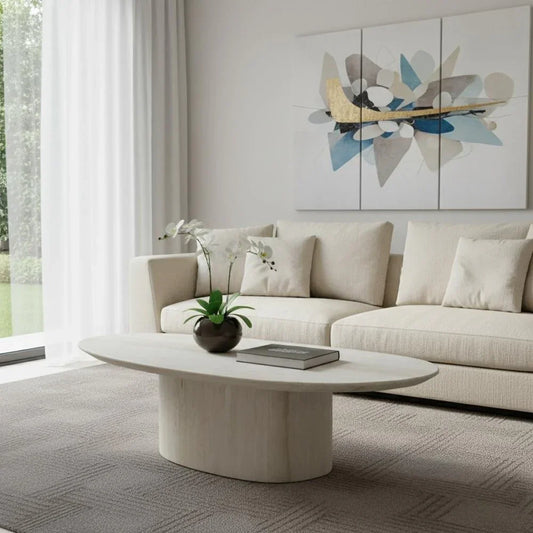 Sia 51-inch beige genuine marble oval pedestal coffee table with a matte finish in a contemporary living room setting.