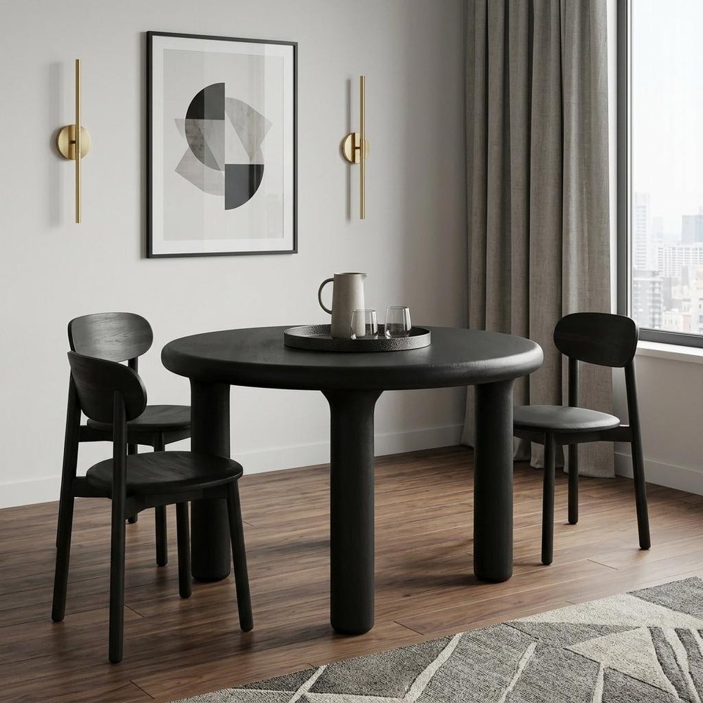 Dining room with a black round table and chairs, abstract art on the wall, and large window.