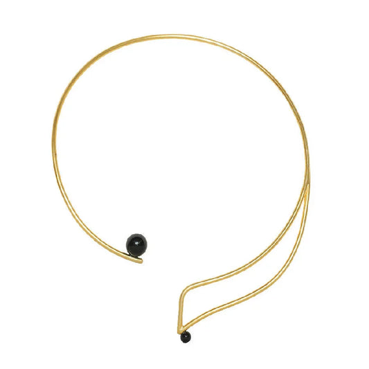 Swara Necklace by Dotto Objects featuring gold-washed brass curves and black stone beads.