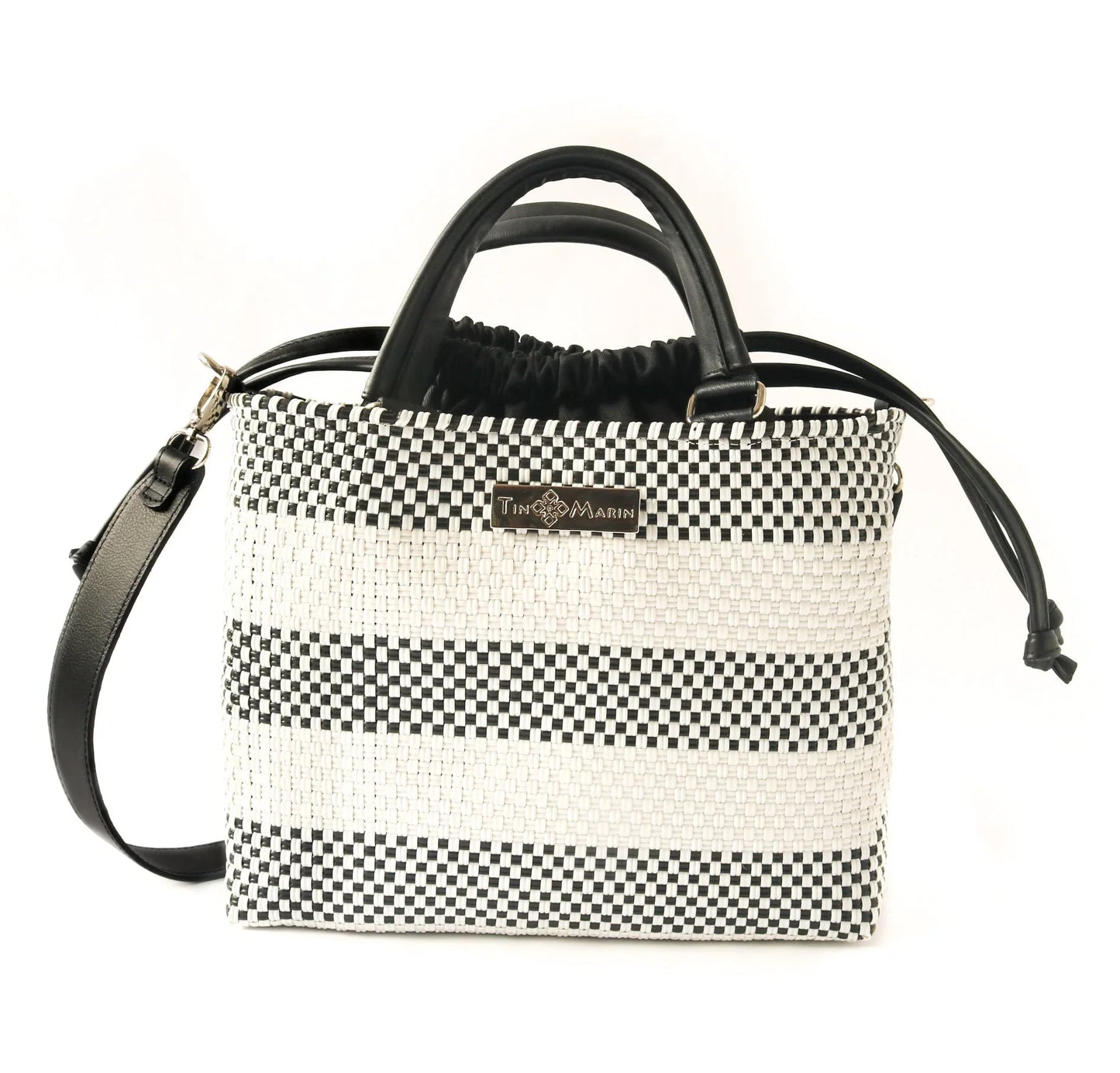 Black and white woven handbag with leather handles and detachable shoulder strap, stylish designer bag
