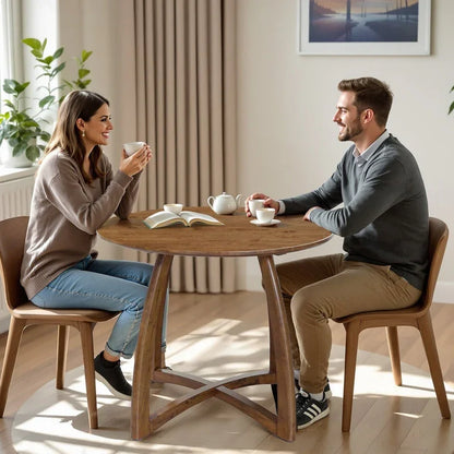 Couple enjoying coffee and conversation at a modern round wooden dining table in a stylish home