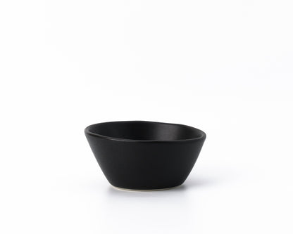 Black ceramic breakfast bowl with smooth matte finish on white background