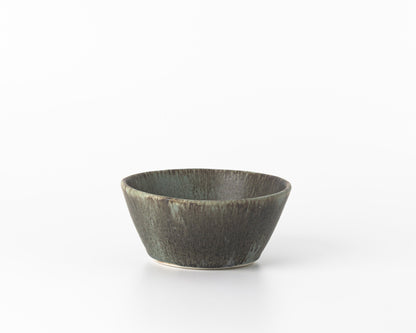 Minimalist small green concrete breakfast bowl on white background
