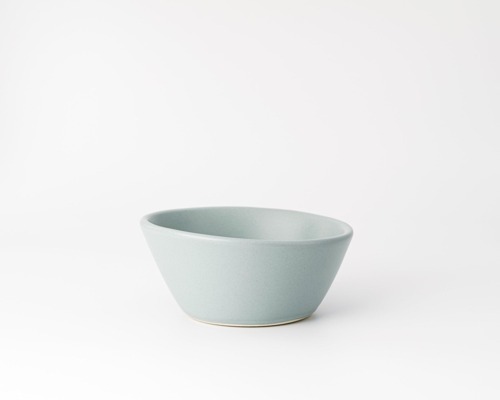 Minimalist grey ceramic breakfast bowl on a white background