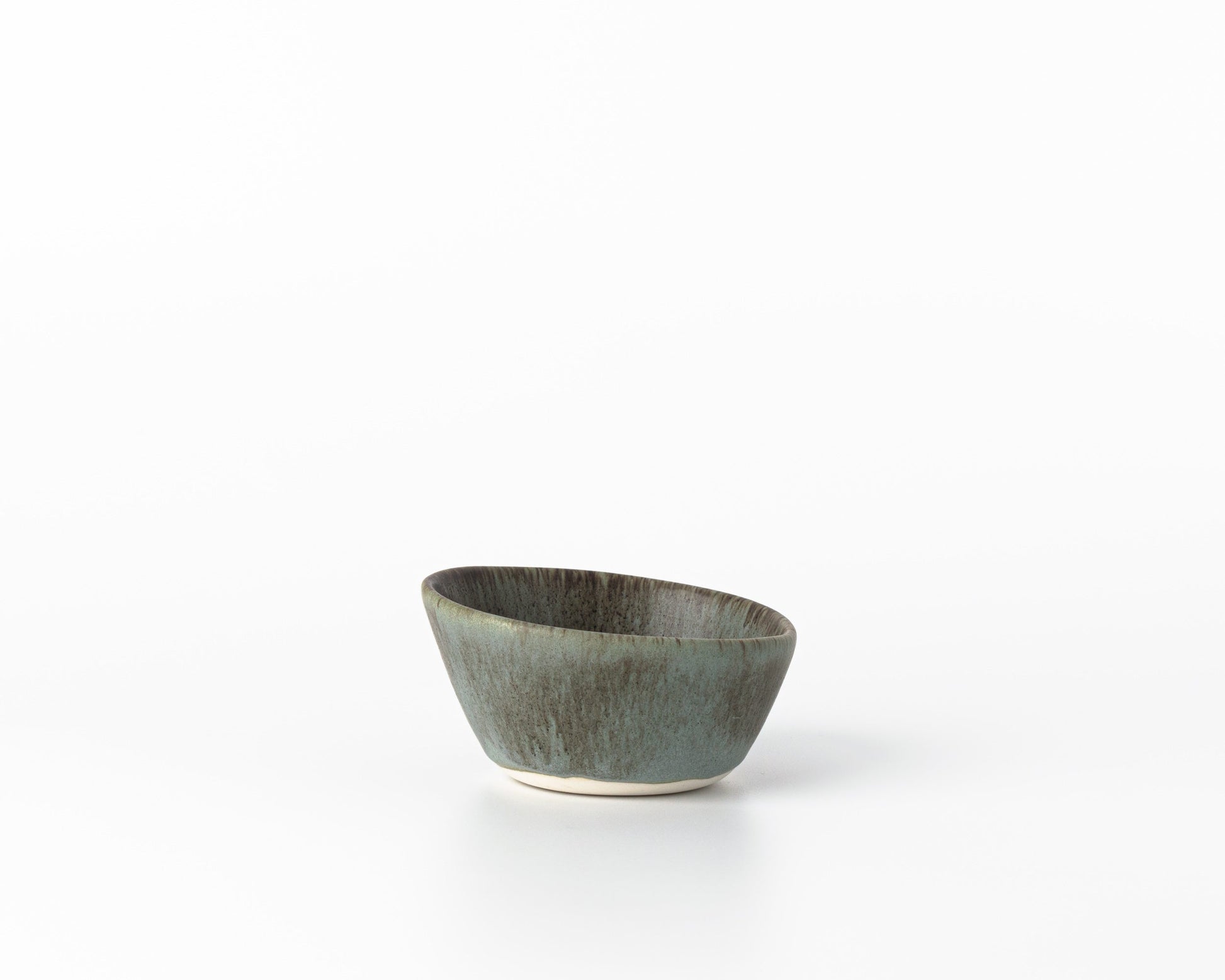 Handcrafted small concrete dessert bowl with greenish-gray glaze on white background