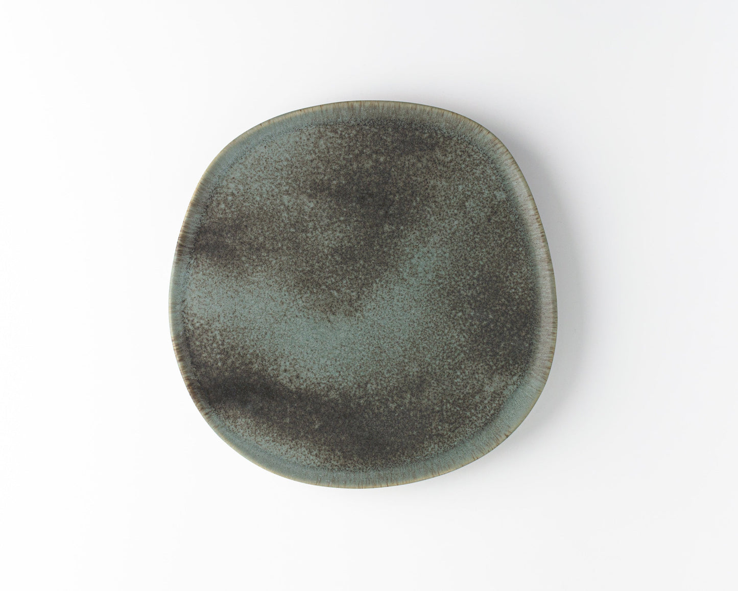 Round ceramic dinner plate with speckled gray and black glaze on white background