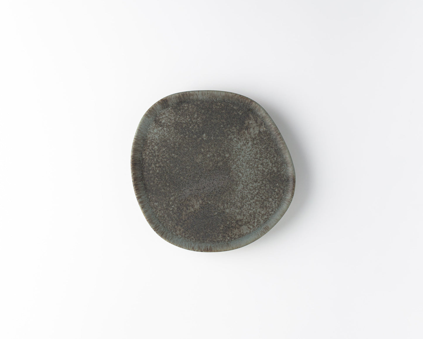 Handcrafted ceramic Ripple Salad plate with textured dark gray glaze on white background