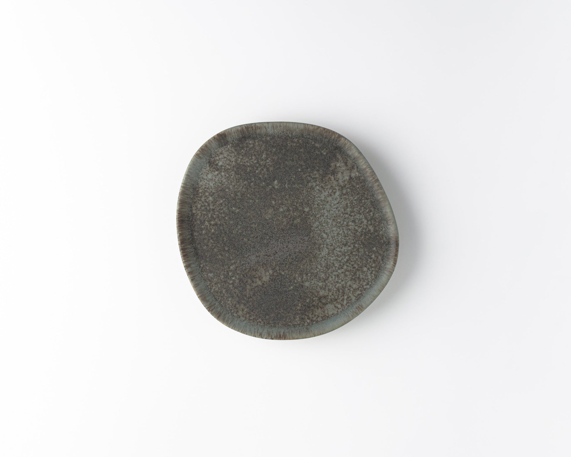 Handcrafted ceramic Ripple Salad plate with textured dark gray glaze on white background