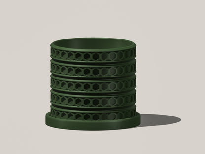 Orion hexagonal plant pot in Green, front view showing geometric lattice design, light gray background