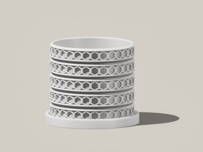 Orion hexagonal plant pot in White, front view showing geometric lattice design, light gray background