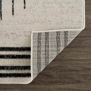 Close-up of the Angus Abstract Black and White Area Rug, showcasing its texture, binding, and polypropylene backing.